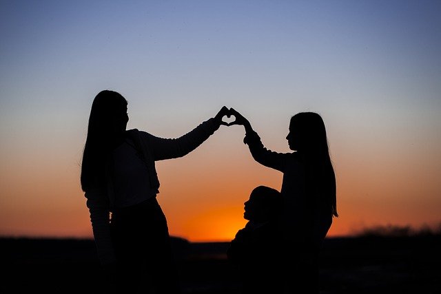 girls holding hands in shape of heart